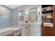 Charming bathroom with blue and white checkered tile, classic fixtures, and built-in shelving, exuding a vintage charm at 310 S Osprey Ave, Sarasota, FL 34236