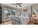 Bright bedroom featuring a metal bed frame, large windows, and neutral tones, creating a serene and inviting atmosphere at 310 S Osprey Ave, Sarasota, FL 34236