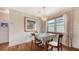 Cozy dining room area with wood floors, an elegant chandelier, and natural light at 310 S Osprey Ave, Sarasota, FL 34236