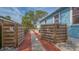 Gated driveway features a brick paver path and leads to the home at 310 S Osprey Ave, Sarasota, FL 34236