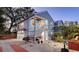 Charming exterior elevation of a two-story home with a red door and a well-maintained yard. Includes an upper-level deck at 310 S Osprey Ave, Sarasota, FL 34236