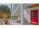Inviting front entrance featuring a bright red door, white stairs, a modern design, and a well landscaped yard at 310 S Osprey Ave, Sarasota, FL 34236