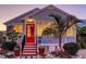 Charming home with a bright red door, complemented by lush landscaping and a quaint, inviting appeal at 310 S Osprey Ave, Sarasota, FL 34236