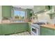 A delightful kitchen featuring green cabinetry, light countertops, and a vintage-style stove at 310 S Osprey Ave, Sarasota, FL 34236