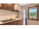 Kitchen with modern appliances, wood cabinets, and a view from the window at 310 S Osprey Ave, Sarasota, FL 34236