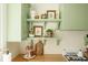 Charming kitchen with decorative open shelves, wooden countertops and green cabinets at 310 S Osprey Ave, Sarasota, FL 34236