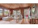 Warm and inviting living room with wood-paneled walls, comfortable seating, and ample natural light at 310 S Osprey Ave, Sarasota, FL 34236