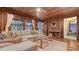 Cozy living room features a comfortable sectional sofa and wood-paneled walls and ceilings at 310 S Osprey Ave, Sarasota, FL 34236