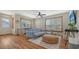 Bright living room featuring hardwood floors, a ceiling fan and natural light from large windows at 310 S Osprey Ave, Sarasota, FL 34236