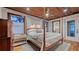 Primary bedroom boasts a four-poster bed, wood plank ceiling, and an ensuite bathroom for a luxurious retreat at 310 S Osprey Ave, Sarasota, FL 34236