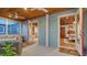Enclosed porch with blue painted walls connects to the inside, with natural lighting and ample seating at 310 S Osprey Ave, Sarasota, FL 34236