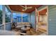 Cozy screened porch with comfortable seating, ceiling fan, and views of the outdoors at 310 S Osprey Ave, Sarasota, FL 34236