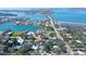 Scenic aerial view of waterfront homes, a bridge, and vibrant blue waters offering a stunning landscape and desirable location at 3530 Flores Ave, Sarasota, FL 34239