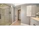 Modern bathroom with glass-enclosed shower, vanity, and neutral color palette, offering a clean design at 3530 Flores Ave, Sarasota, FL 34239