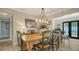 Elegant dining room featuring hardwood floors, a rustic table set, and ample space for Gathering gatherings at 3530 Flores Ave, Sarasota, FL 34239
