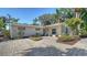 Inviting single-story home showcasing a brick-paved driveway, complemented by well-maintained landscaping and a cozy outdoor seating area at 3530 Flores Ave, Sarasota, FL 34239