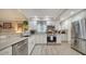 Well-appointed kitchen featuring stainless steel appliances, white cabinetry, and stylish backsplash at 3530 Flores Ave, Sarasota, FL 34239