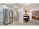 Kitchen view with stainless steel refrigerator, opening to bedroom and other living space at 3530 Flores Ave, Sarasota, FL 34239