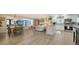 Open-concept living space featuring wood floors, a modern kitchen, dining area, and a cozy living room at 3530 Flores Ave, Sarasota, FL 34239