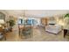 Open-concept living space featuring a dining area, a cozy living room with a fireplace, and ample natural light at 3530 Flores Ave, Sarasota, FL 34239