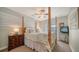 Comfortable bedroom featuring a four-poster bed, a nightstand, and soft lighting creating a relaxing retreat at 3530 Flores Ave, Sarasota, FL 34239