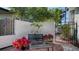 Cozy outdoor patio with a garden bench, potted plants, and a peaceful atmosphere at 3530 Flores Ave, Sarasota, FL 34239
