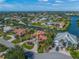 Aerial view of the beautiful waterfront property, mature trees, and circle driveway at 364 El Greco Dr, Osprey, FL 34229