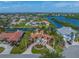 Aerial view of the waterfront property showcasing the home, its location on the water, and circular driveway at 364 El Greco Dr, Osprey, FL 34229