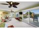 Spacious bedroom with ceiling fan, seating area, and large sliding glass doors to outdoor deck at 364 El Greco Dr, Osprey, FL 34229