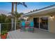 Charming deck with blue Adirondack chairs offering views of the lush tropical surroundings at 364 El Greco Dr, Osprey, FL 34229