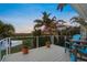 Deck overlooking river features seating area with blue chairs and decorative flower pots at 364 El Greco Dr, Osprey, FL 34229