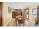 Comfortable dining room with wood floors and cabinets, plenty of natural light, and seating for four at 364 El Greco Dr, Osprey, FL 34229