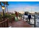 Private boat dock with boat lift and Adirondack chairs, perfect for enjoying waterfront living at 364 El Greco Dr, Osprey, FL 34229