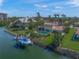 Waterfront home featuring a private dock, a swimming pool, lush landscaping and gorgeous palm trees at 364 El Greco Dr, Osprey, FL 34229