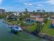 Waterfront home featuring a private dock, a swimming pool, lush landscaping and gorgeous palm trees at 364 El Greco Dr, Osprey, FL 34229
