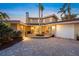 Beautiful two-story home with a red tile roof, lush landscaping, and a welcoming entrance at 364 El Greco Dr, Osprey, FL 34229