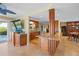 Open-concept kitchen with granite countertops, custom cabinets, and an island with seating, perfect for entertaining at 364 El Greco Dr, Osprey, FL 34229