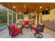 Covered outdoor living space with a built-in grill, bar area, comfortable seating and a ceiling fan at 364 El Greco Dr, Osprey, FL 34229