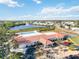 A high-angle shows the waterfront clubhouse with pool, shuffleboard, & beautiful landscaping at 4528 Fern Dr, Bradenton, FL 34208