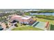Waterfront community with a clubhouse, pool, and shuffleboard courts, aerial view at 4528 Fern Dr, Bradenton, FL 34208
