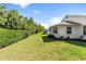 Spacious backyard with green grass and mature trees, perfect for outdoor activities at 4528 Fern Dr, Bradenton, FL 34208