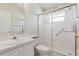 Bathroom with glass shower, white fixtures and vanity at 4528 Fern Dr, Bradenton, FL 34208
