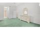 Calm bedroom features a mirror on dresser, soft green carpet, and a bright window at 4528 Fern Dr, Bradenton, FL 34208