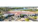 A beautiful community clubhouse with a red tile roof and golf carts parked outside at 4528 Fern Dr, Bradenton, FL 34208