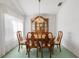 Elegant dining room featuring a wood table with six chairs, complemented by a vintage hutch at 4528 Fern Dr, Bradenton, FL 34208
