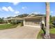 Attached two-car garage and a well-manicured front lawn with lush landscaping at 4528 Fern Dr, Bradenton, FL 34208