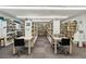 Library featuring tables, chairs and rows of books at 4528 Fern Dr, Bradenton, FL 34208