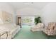 Spacious living room featuring neutral-toned furniture, vaulted ceilings, and an open layout to sunroom at 4528 Fern Dr, Bradenton, FL 34208
