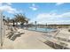 Community swimming pool area with lounge chairs and clear blue skies at 4528 Fern Dr, Bradenton, FL 34208
