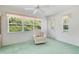 Bright sunroom featuring a comfortable recliner, lots of natural light, and verdant views from the large window at 4528 Fern Dr, Bradenton, FL 34208